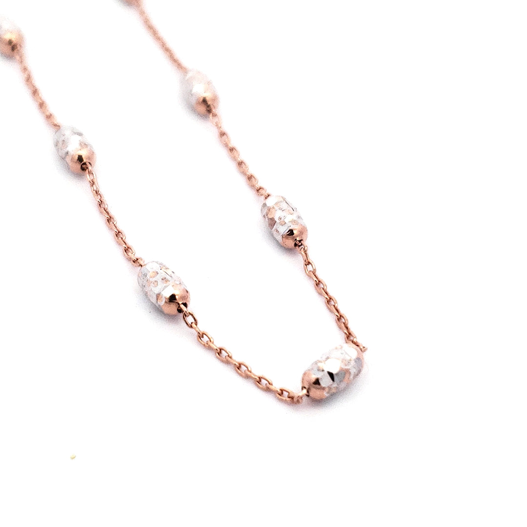 A 10K 2 Tone Rose Gold Anklet with adjustable chain and rose gold beads, featuring a custom packaging and an authentic Dana Dow Jewellers box.