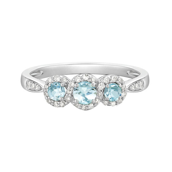 Silver ring with three light blue gemstones on a white background