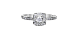 A 10K white gold engagement ring with a central Canadian diamond and smaller diamonds set in a halo design.