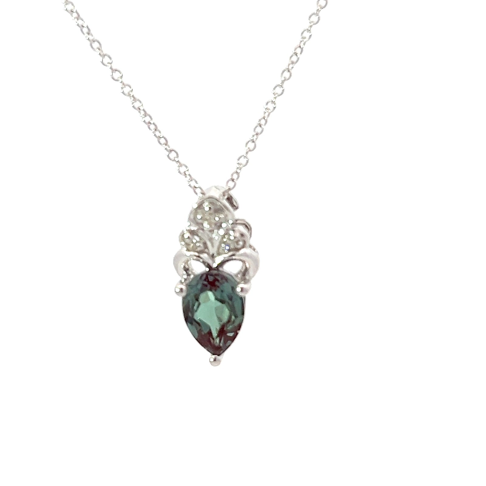 Silver necklace with a green teardrop pendant on a white background
