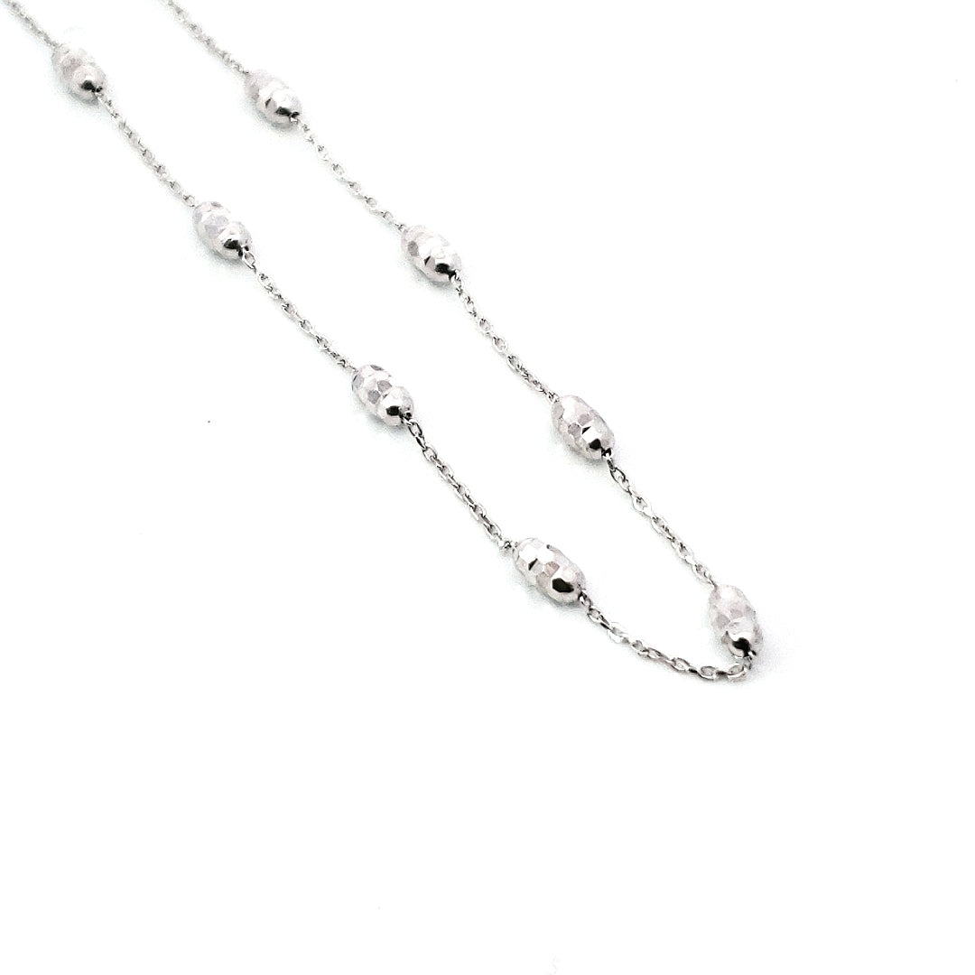 10K white gold anklet with adjustable 9-10 inch length, featuring a series of round beads and a metallic clasp.