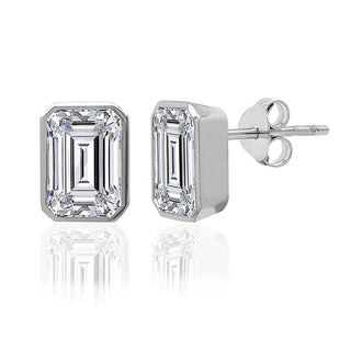 Pair of emerald-cut diamond stud earrings on a white background