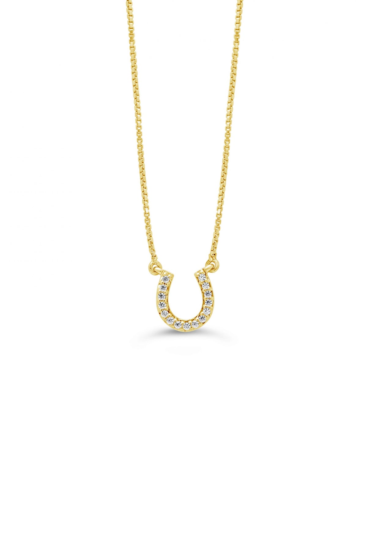 A 10K yellow gold horseshoe pendant with diamond accents on a white background.