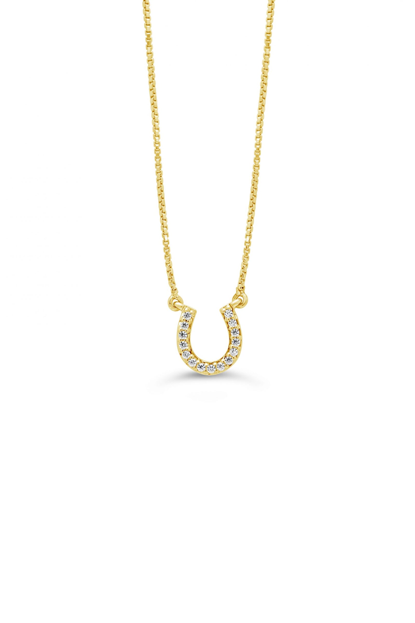 A 10K yellow gold horseshoe pendant with diamond accents on a white background.