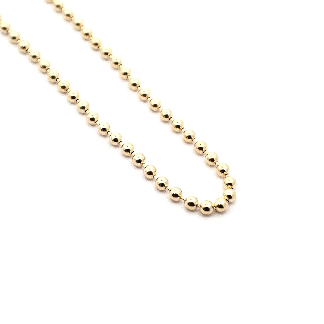A 10K yellow gold anklet with adjustable beads and a 1-inch adjuster, presented against a white background.