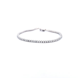 A 14K white gold tennis bracelet with lab grown diamonds, featuring a single row of diamonds around the wrist.
