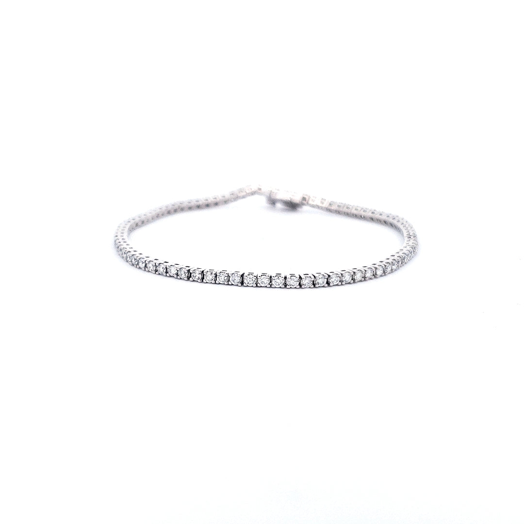A 14K white gold tennis bracelet with lab grown diamonds, featuring a single row of diamonds around the wrist.