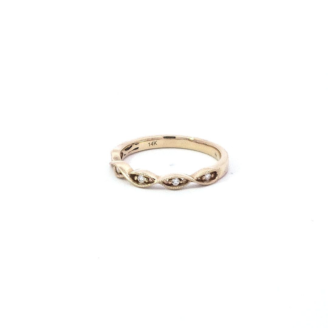 A 14K yellow gold diamond milgrain ring with multiple bands and round cut white diamonds.