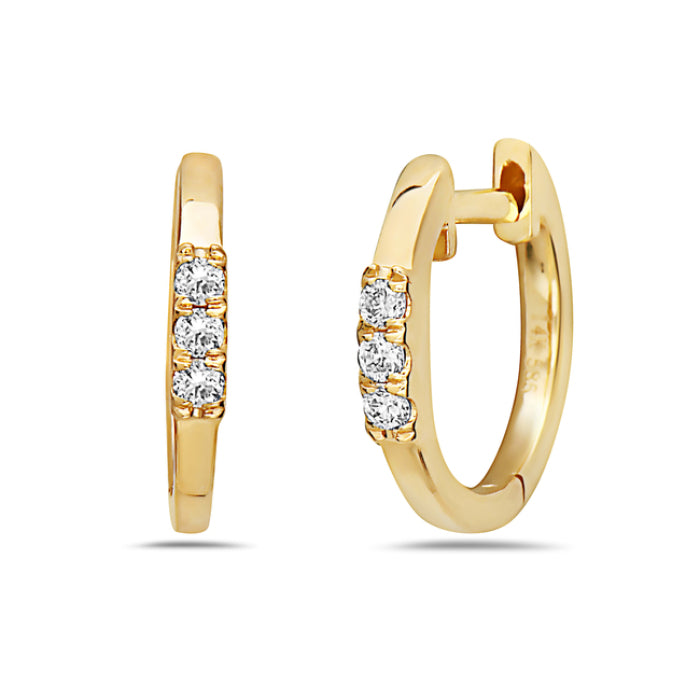 A pair of 14K yellow gold hoop earrings with diamonds set in the hoops.