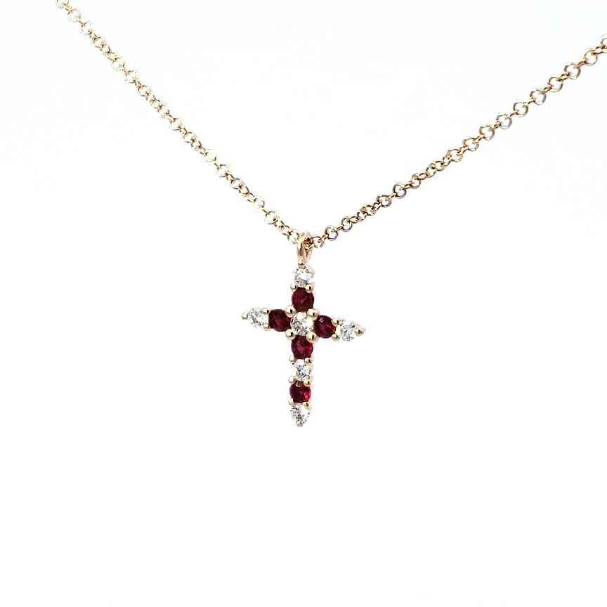 A 14K yellow gold pendant featuring a red ruby and white diamond in a cross design, attached to a gold cable chain.
