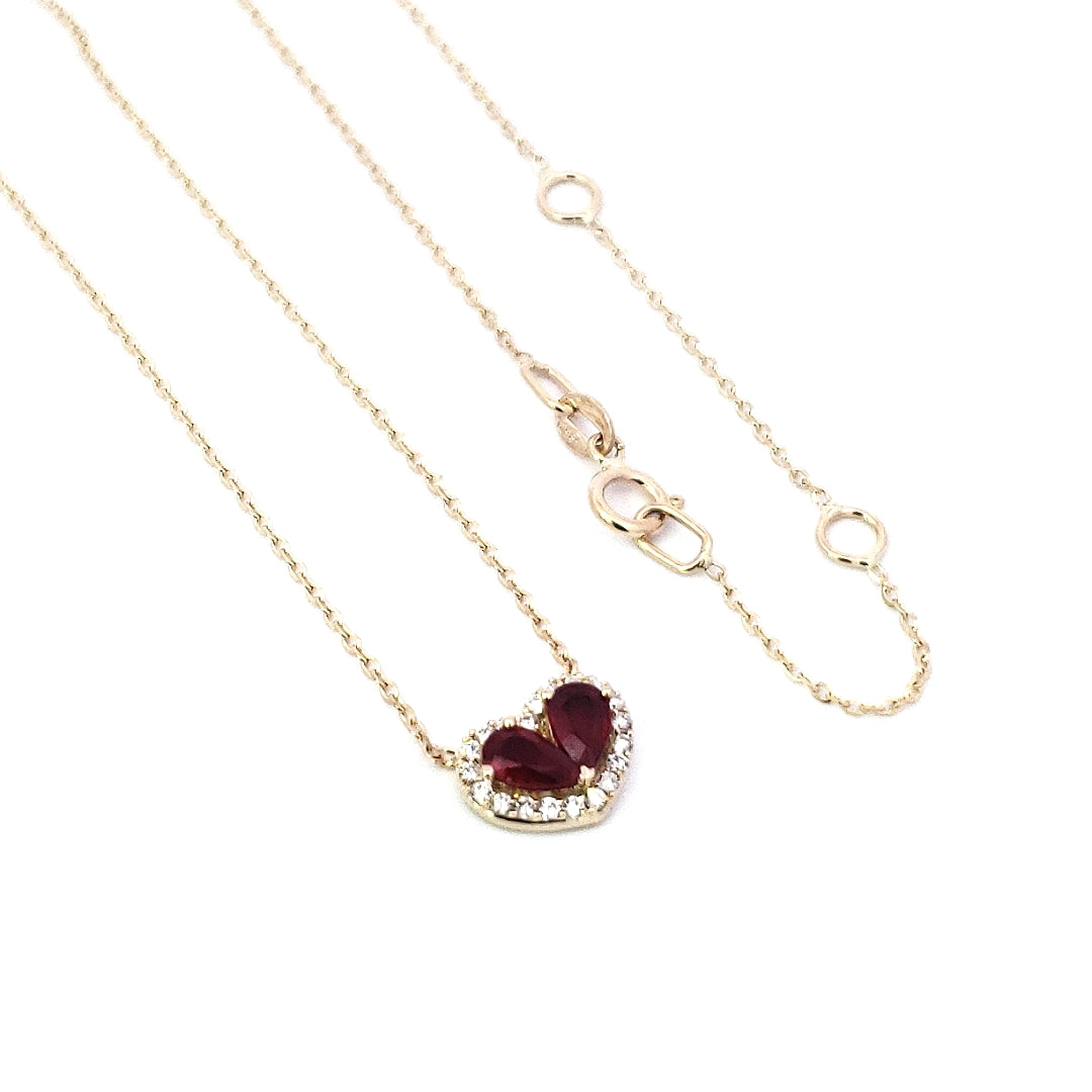 A 14K yellow gold necklace featuring a 0.50cttw ruby pendant and a smaller 0.