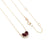 A 14K yellow gold necklace featuring a 0.50cttw ruby pendant and a smaller 0.