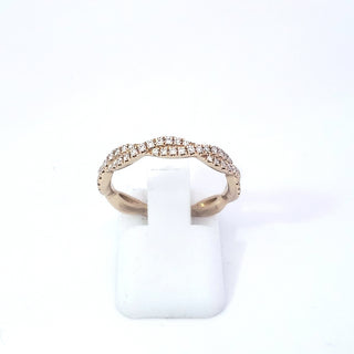 A 14K yellow gold wavy diamond band ring displayed on a white band, with a total of 0.27 carats of diamonds set in the band.