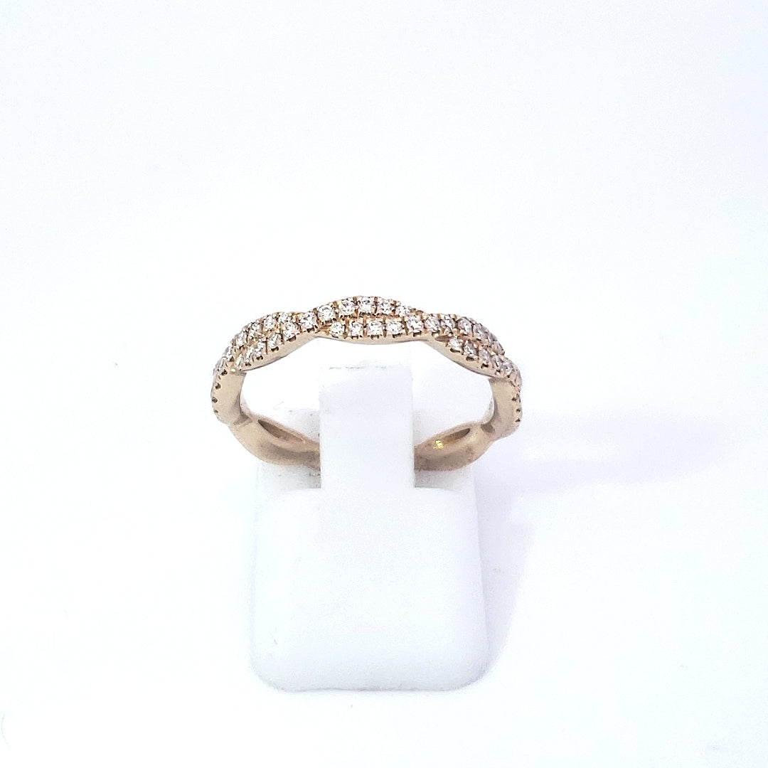 A 14K yellow gold wavy diamond band ring displayed on a white band, with a total of 0.27 carats of diamonds set in the band.