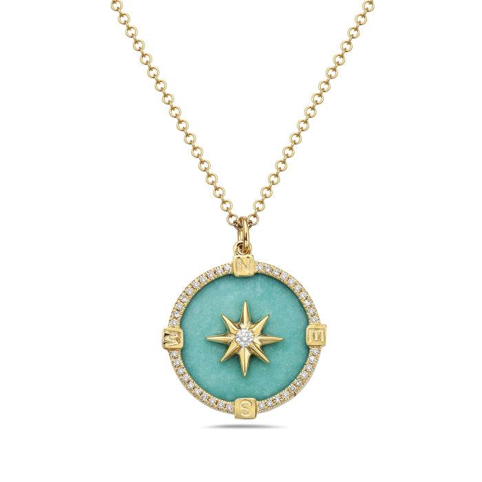 A 14K yellow gold necklace with a turquoise compass design and a central diamond, surrounded by smaller clear stones.
