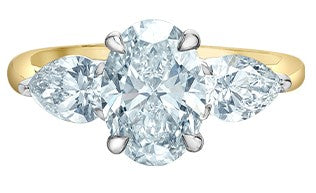 A three-stone lab grown diamond engagement ring with yellow and white gold.