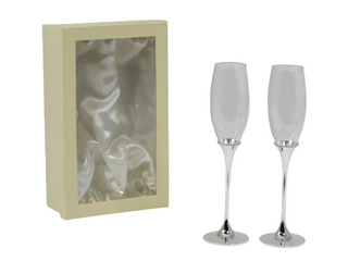 Two champagne flutes with silver bases in front of a beige box.