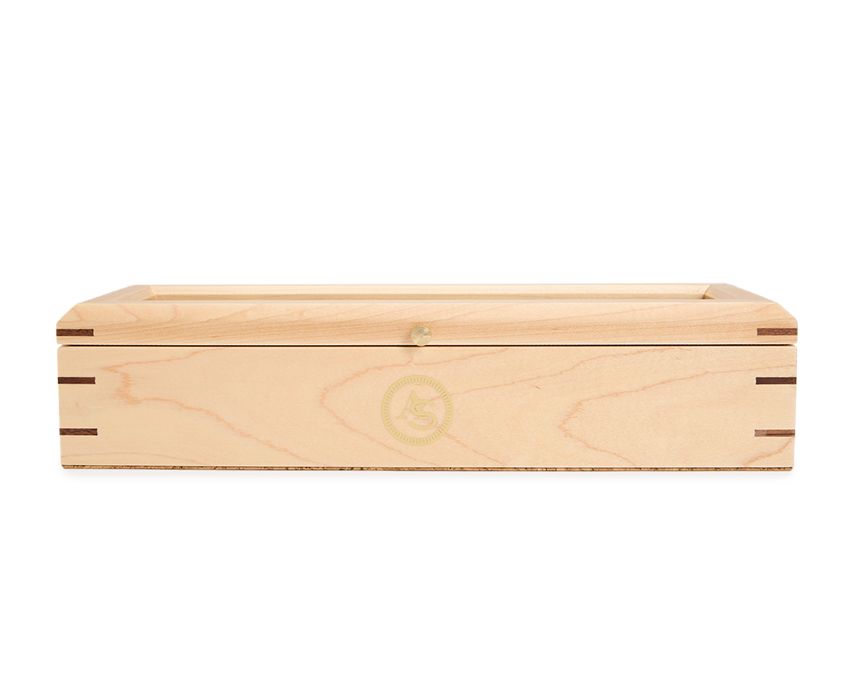A rectangular beige wooden watch box with a natural walnut inlay exterior and a gold foil logo on the lid.
