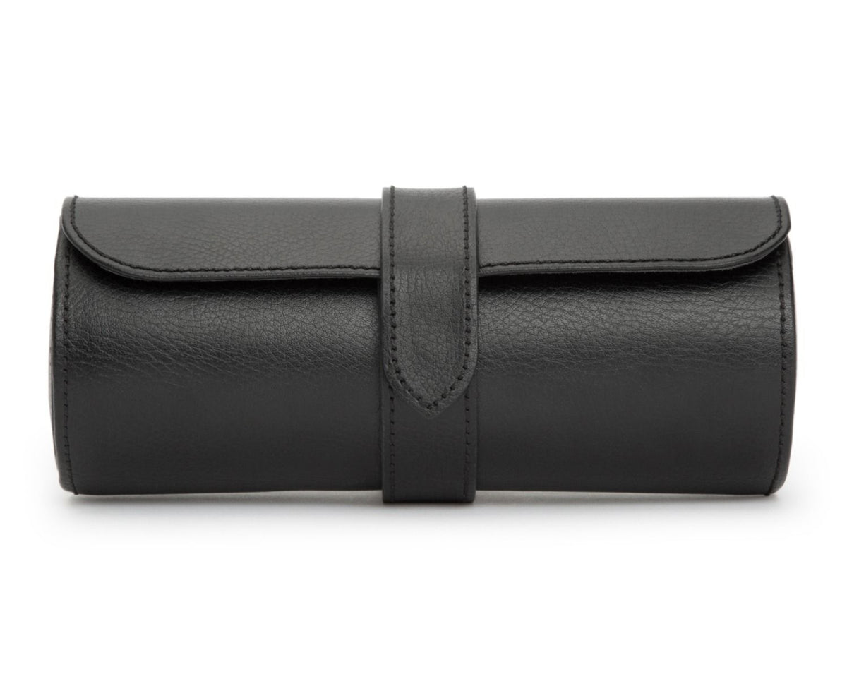 A black leather watch roll with a snap closure and a hidden jewelry capsule, designed to hold multiple watches.
