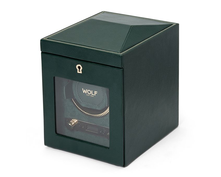 A green single watch winder with a branded WOLF logo on the front, featuring a clear viewing window and a fluted bezel design.
