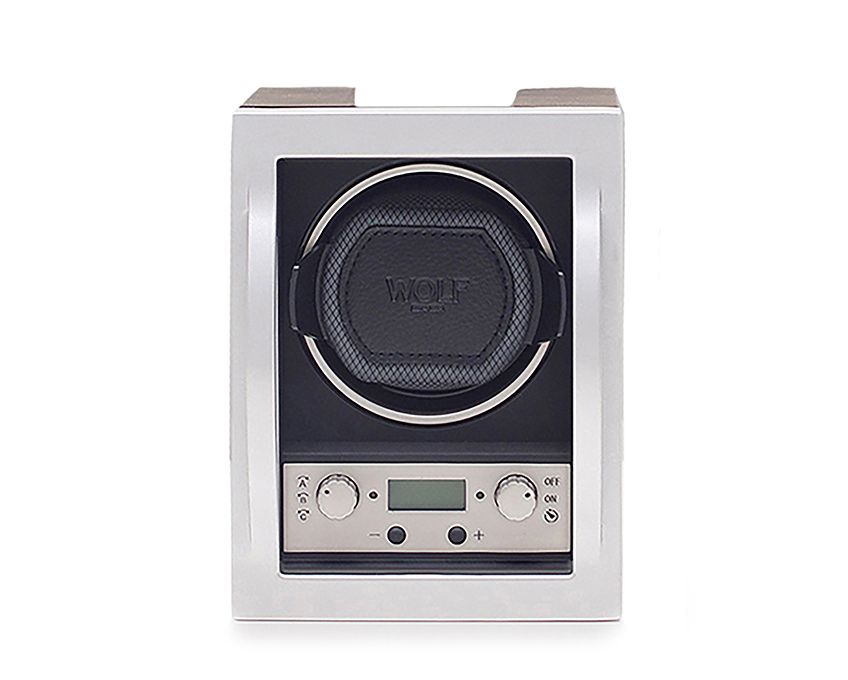 A WOLF brand watch winder with a digital display and control knobs, primarily in black and silver colors.