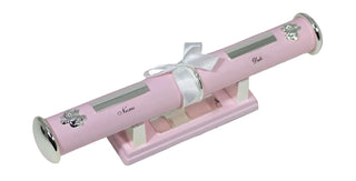 Pink cylindrical gift box with silver accents and a white ribbon on a white background