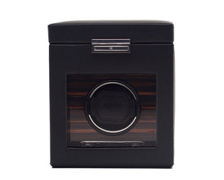 A black single watch winder with a wooden storage compartment, featuring a chrome spoked wheel design and a leather-like surface.