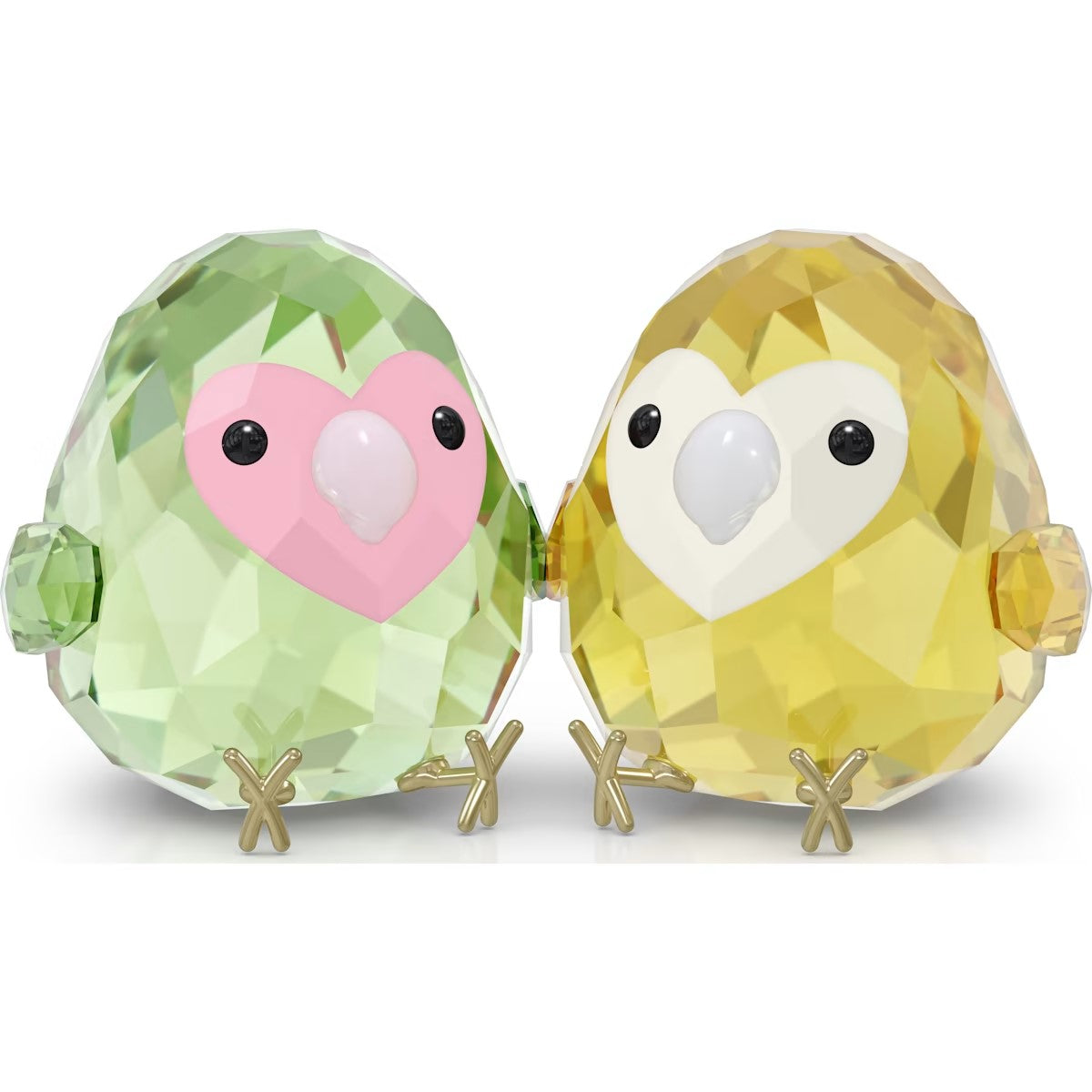 Two crystal bird figurines, one green and one yellow, on a white background
