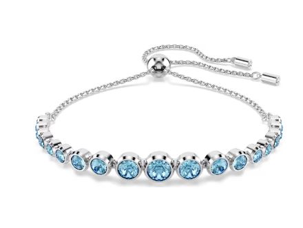 A rhodium-plated bracelet with a gradient of round-cut blue crystals, featuring a modern bezel setting on a soft chain with a sliding closure.