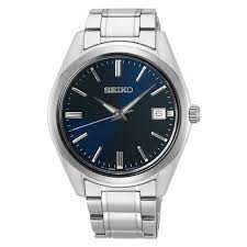 A SEIKO men's watch with a stainless steel band and a blue dial, featuring a date display and LumiBrite hands.