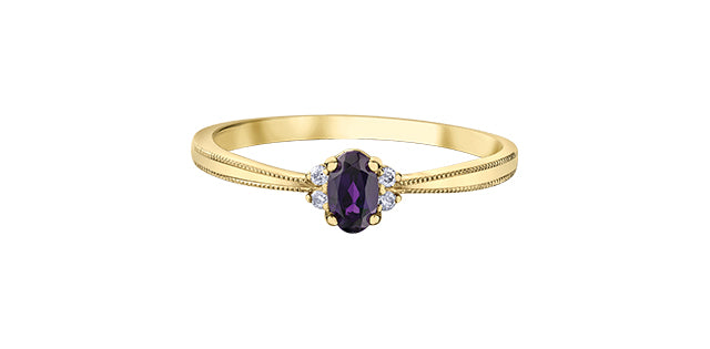 Gold ring with a purple gemstone on a white background