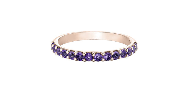Rose gold ring with purple gemstones on a white background