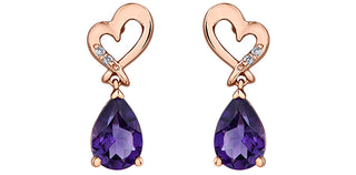 Rose gold heart-shaped earrings with purple teardrop gemstones on a white background