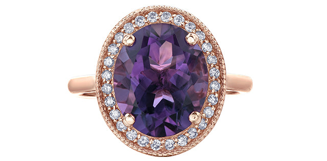 Ring with purple gemstone and rose gold band on white background