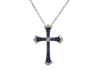 Cross-shaped pendant with blue stones and a diamond on a white background
