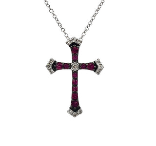 Silver cross necklace with red gemstones on a white background