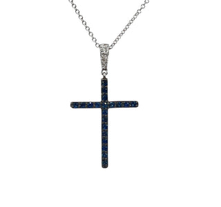 Cross-shaped pendant with blue stones and a chain on a white background