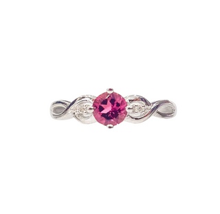 Silver ring with a pink gemstone on a white background