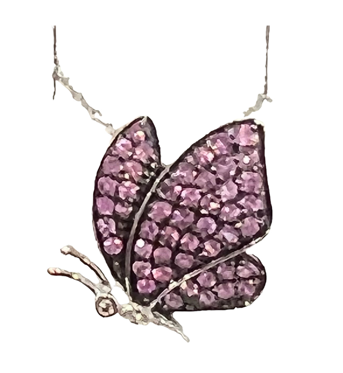 Butterfly pendant with pink gemstones on a white background