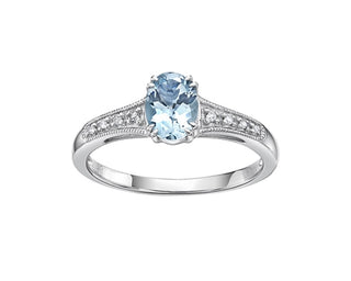 Silver ring with a blue gemstone and diamond accents on a white background