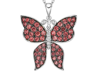 Butterfly pendant with red gemstones on a white background