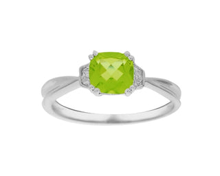 Silver ring with a green gemstone on a white background