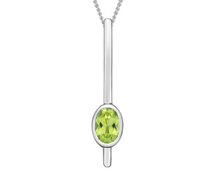 Silver pendant with a green gemstone on a white background