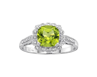 Ring with a green gemstone and diamond accents on a white background