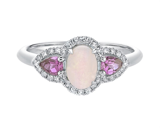 Silver ring with pink gemstones on a white background