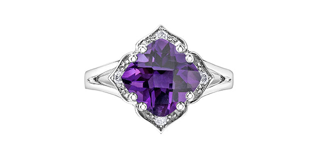 Silver ring with a purple heart-shaped gemstone on a white background