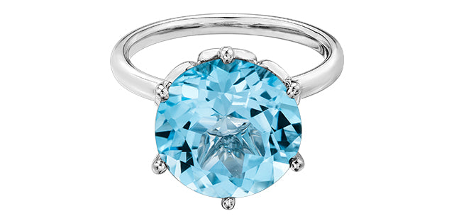 Silver ring with a large blue gemstone on a white background