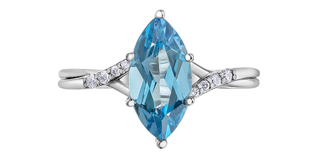 white gold ring with a large blue gemstone and smaller diamonds on a white background