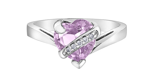 Silver ring with a pink heart-shaped gemstone on a white background