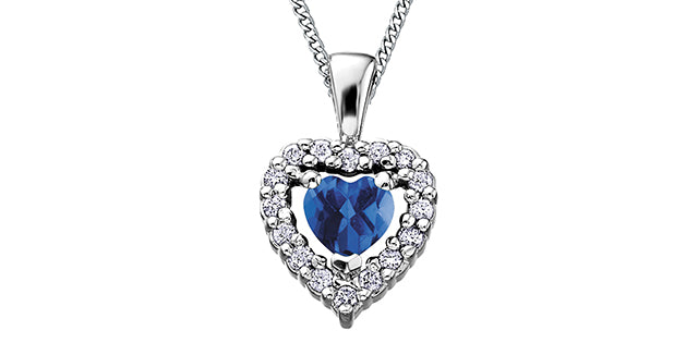 Heart-shaped pendant with blue gemstone and clear stones on a white background